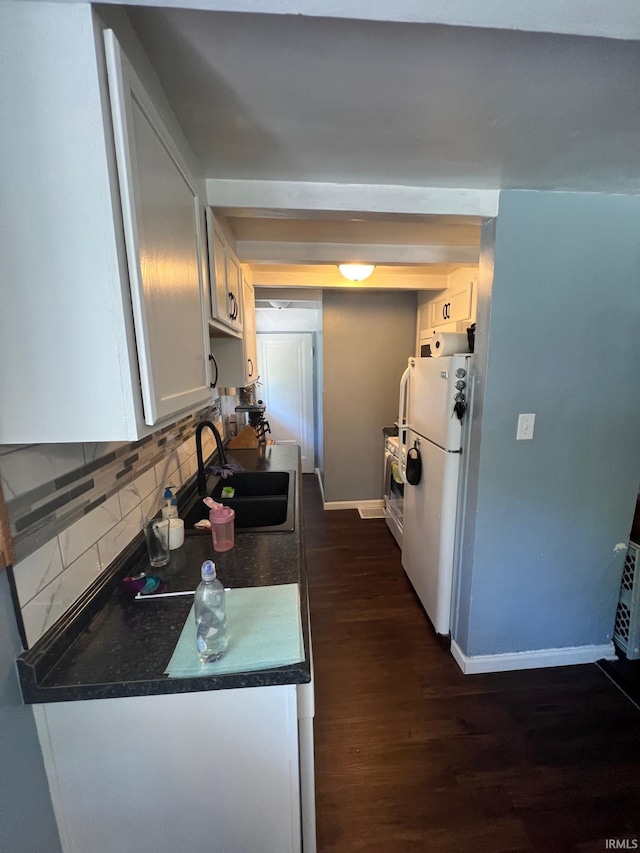 1206 King St, Lafayette, IN 47905 - kitchen with a sink, dark wood finished floors, tasteful backsplash, baseboards, and freestanding refrigerator