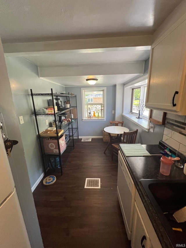 1206 King St, Lafayette, IN 47905 - kitchen with white dishwasher, dark wood-style floors, a sink, baseboards, and beamed ceiling