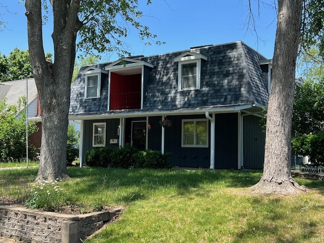 1206 King St, Lafayette, IN 47905 - view of front of house featuring board and batten siding, a front yard, roof with shingles, and mansard roof