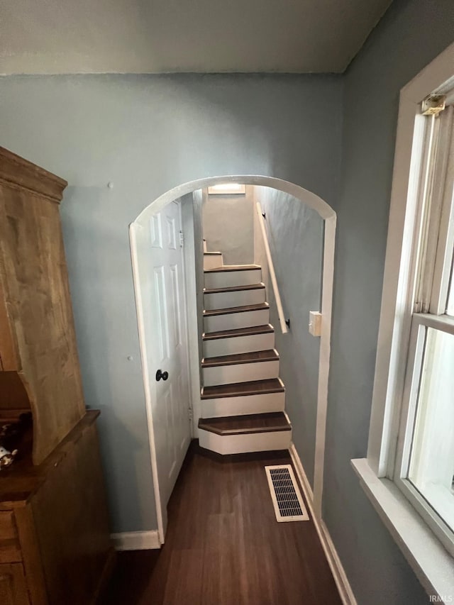 1206 King St, Lafayette, IN 47905 - staircase featuring wood finished floors, arched walkways, and baseboards