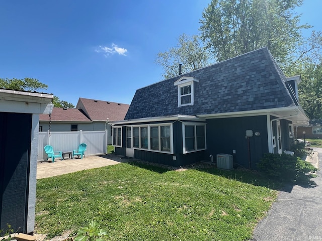 1206 King St, Lafayette, IN 47905 - rear view of property featuring cooling unit, a shingled roof, a patio area, a sunroom, and mansard roof