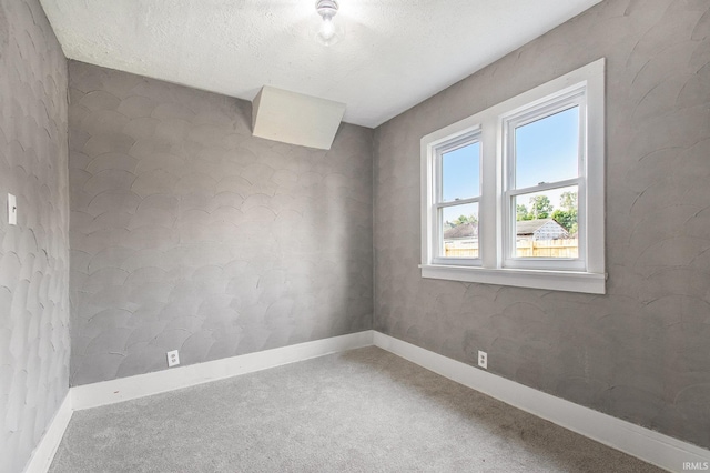 1614 Kendall St, South Bend, IN 46613 - carpeted empty room with baseboards and a textured ceiling