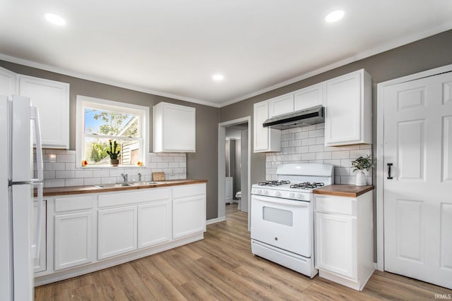 1614 Kendall St, South Bend, IN 46613 - kitchen with white appliances, under cabinet range hood, butcher block countertops, a sink, and decorative backsplash