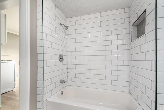 1614 Kendall St, South Bend, IN 46613 - full bathroom with shower / bathtub combination, wood finished floors, a textured ceiling, and washer / dryer