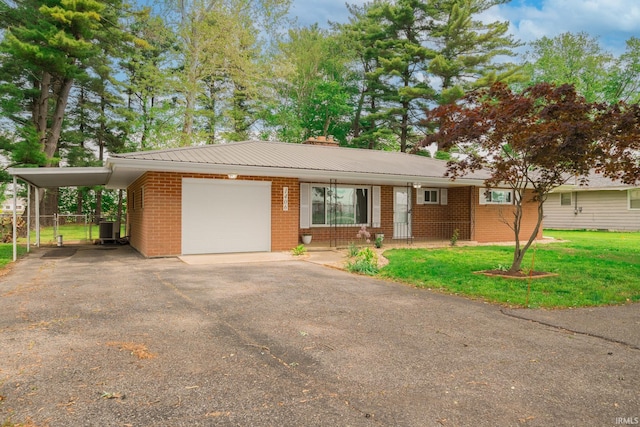 1406 W 38th St, Marion, IN 46953 - ranch-style house with driveway, brick siding, central AC unit, a garage, and a carport