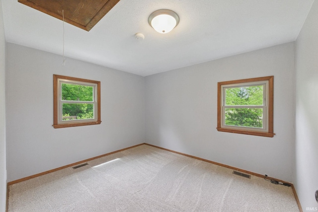 7956 N 225 W, Delphi, IN 46923 - unfurnished room with attic access, baseboards, a smoke detector, and light colored carpet
