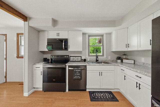 7956 N 225 W, Delphi, IN 46923 - kitchen featuring dishwashing machine, stainless steel electric stove, a sink, light wood-style flooring, and white cabinetry