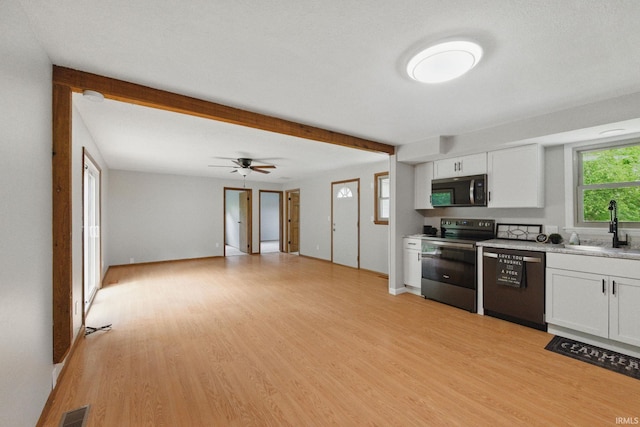 7956 N 225 W, Delphi, IN 46923 - kitchen featuring stainless steel appliances, a sink, white cabinetry, and light wood-style flooring