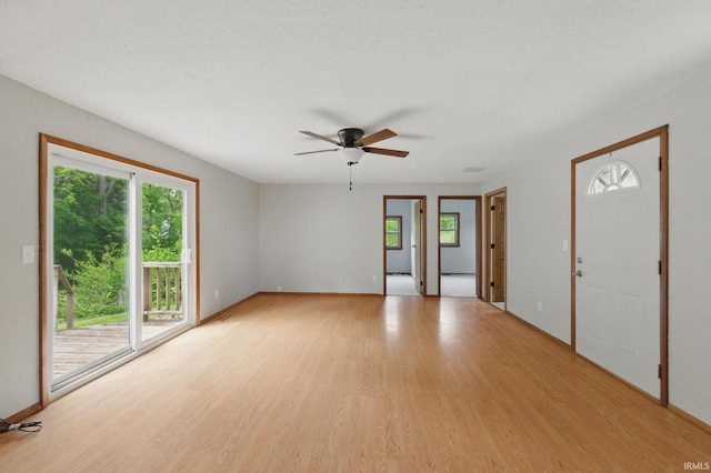 7956 N 225 W, Delphi, IN 46923 - unfurnished room featuring healthy amount of natural light, light wood-style floors, a ceiling fan, and baseboards