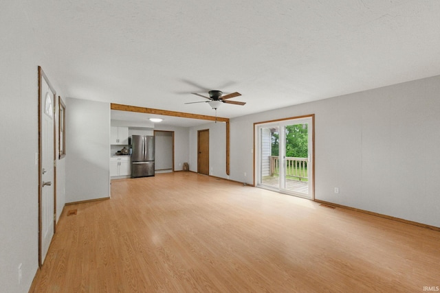 7956 N 225 W, Delphi, IN 46923 - unfurnished living room with a ceiling fan, light wood finished floors, and baseboards