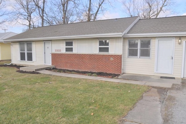 3333 Eastwood Dr, Fort Wayne, IN 46805 - view of front of property with brick siding, a front lawn, and roof with shingles