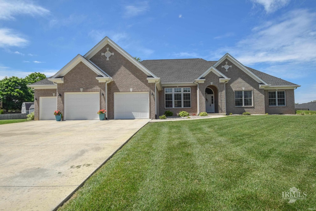 805 W Barouche, Pendleton, IN 46064 - view of front of property featuring a front lawn, brick siding, concrete driveway, and an attached garage
