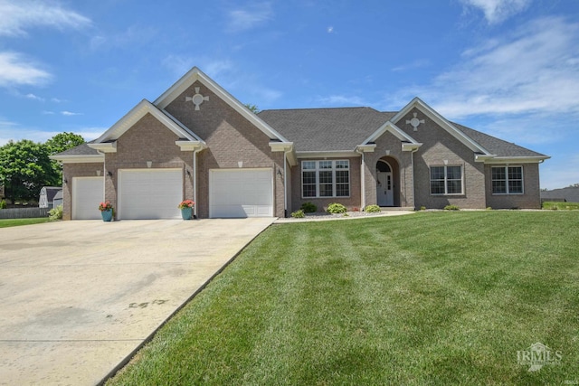 805 W Barouche, Pendleton, IN 46064 - view of front of property featuring a front lawn, brick siding, concrete driveway, and an attached garage