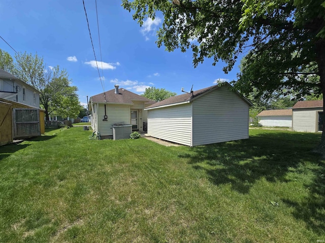 rear view of property featuring a lawn