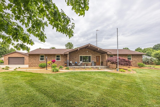 1376 N Hayland Dr, Jasper, IN 47546 - ranch-style house with brick siding, a front yard, and a detached garage