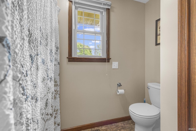 1376 N Hayland Dr, Jasper, IN 47546 - bathroom with baseboards, toilet, and a shower with shower curtain