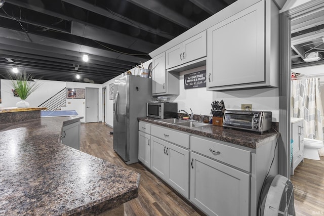 1376 N Hayland Dr, Jasper, IN 47546 - kitchen with a sink, dark countertops, stainless steel appliances, dark wood-style flooring, and white cabinets