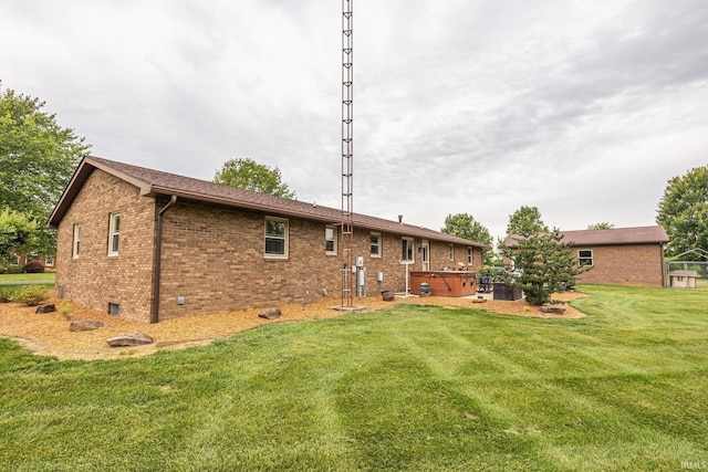 1376 N Hayland Dr, Jasper, IN 47546 - back of property with a hot tub, brick siding, and a yard