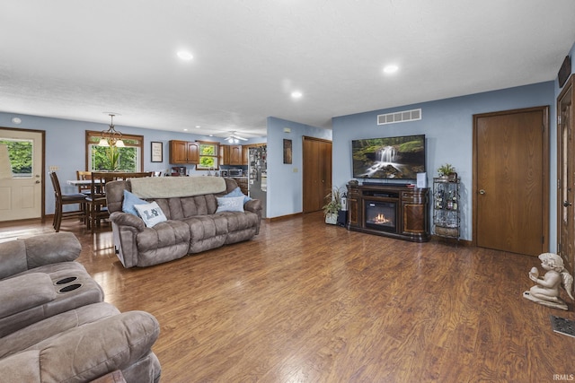 1376 N Hayland Dr, Jasper, IN 47546 - living area with dark wood-style floors, a glass covered fireplace, recessed lighting, baseboards, and a ceiling fan