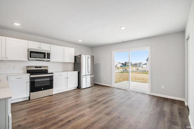 2170 Miami Trl, Huntington, IN 46750 - kitchen featuring stainless steel appliances, light countertops, decorative backsplash, baseboards, and recessed lighting