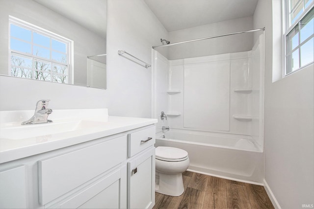 2170 Miami Trl, Huntington, IN 46750 - bathroom featuring wood finished floors, toilet, vanity, washtub / shower combination, and baseboards