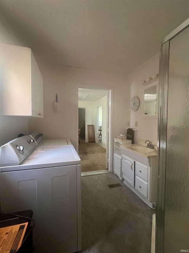 509 E Vincennes St, Orleans, IN 47452 - washroom featuring washer and clothes dryer, dark colored carpet, and cabinet space