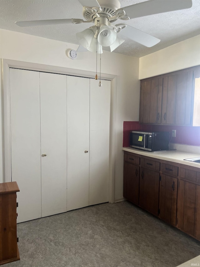 509 E Vincennes St, Orleans, IN 47452 - kitchen with light countertops, ceiling fan, a textured ceiling, and dark brown cabinets