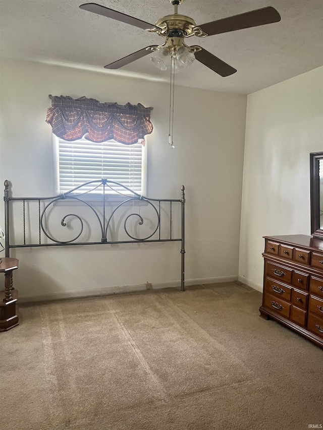 509 E Vincennes St, Orleans, IN 47452 - unfurnished bedroom with carpet, a ceiling fan, and baseboards