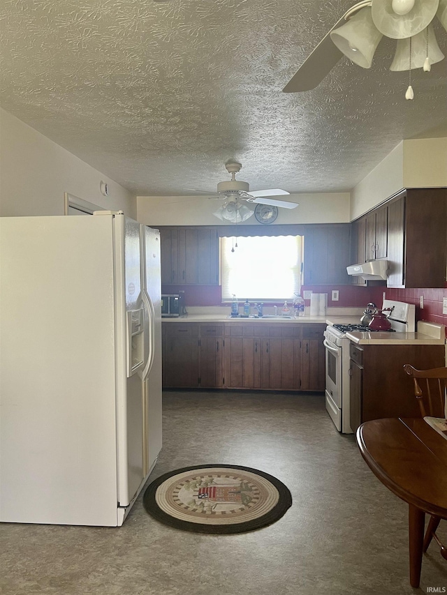 509 E Vincennes St, Orleans, IN 47452 - kitchen featuring white appliances, a ceiling fan, under cabinet range hood, light countertops, and a textured ceiling