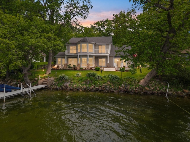 135 Ems D13 Ln, Syracuse, IN 46567 - rear view of house with a water view, a lawn, and a balcony
