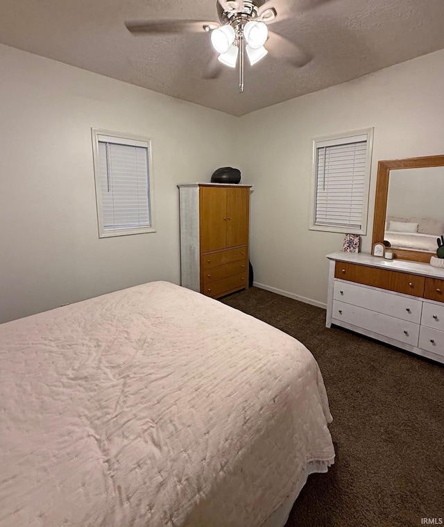 2146 N 20th St, Terre Haute, IN 47804 - bedroom with dark colored carpet, baseboards, and a ceiling fan