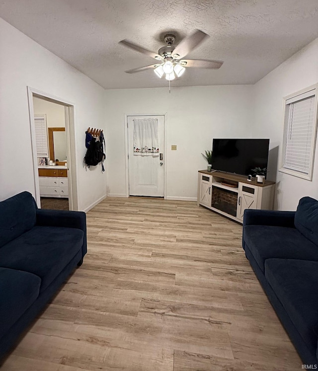 2146 N 20th St, Terre Haute, IN 47804 - living area featuring ceiling fan, light wood finished floors, a textured ceiling, and baseboards