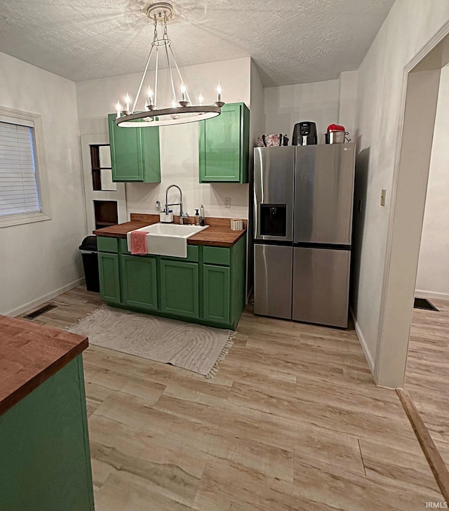 2146 N 20th St, Terre Haute, IN 47804 - kitchen featuring green cabinets, wood counters, stainless steel fridge, light wood-style flooring, and a chandelier