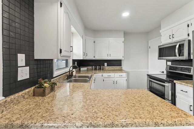 8020 Marston Dr, Fort Wayne, IN 46835 - kitchen featuring stainless steel appliances, a sink, tasteful backsplash, white cabinets, and recessed lighting