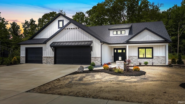 13335 Passerine Blvd, Fort Wayne, IN 46845 - modern inspired farmhouse with stone siding, a garage, roof with shingles, concrete driveway, and board and batten siding