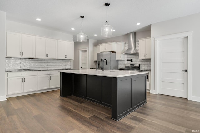 13335 Passerine Blvd, Fort Wayne, IN 46845 - kitchen featuring wall chimney exhaust hood, appliances with stainless steel finishes, backsplash, white cabinets, and recessed lighting