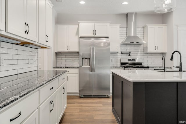 13335 Passerine Blvd, Fort Wayne, IN 46845 - kitchen with appliances with stainless steel finishes, wall chimney exhaust hood, a sink, white cabinets, and decorative backsplash
