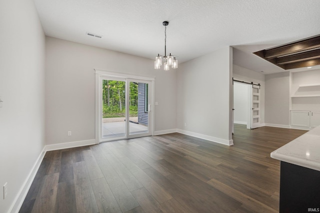 13335 Passerine Blvd, Fort Wayne, IN 46845 - unfurnished dining area featuring a barn door, dark wood-type flooring, and baseboards