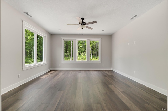 13335 Passerine Blvd, Fort Wayne, IN 46845 - unfurnished room featuring plenty of natural light, ceiling fan, dark wood-style flooring, and baseboards