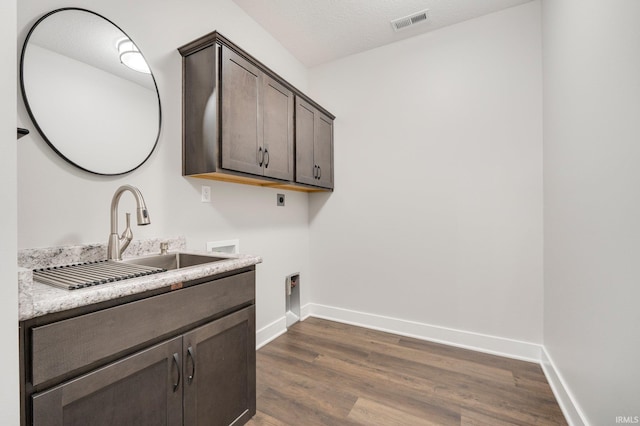 13335 Passerine Blvd, Fort Wayne, IN 46845 - washroom with cabinet space, hookup for an electric dryer, hookup for a washing machine, baseboards, and dark wood-style flooring