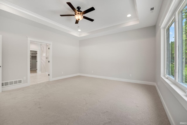 13335 Passerine Blvd, Fort Wayne, IN 46845 - spare room with light colored carpet, a ceiling fan, a raised ceiling, recessed lighting, and baseboards