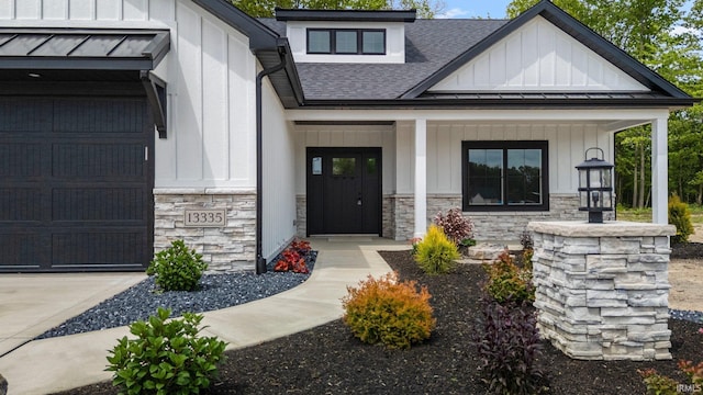 13335 Passerine Blvd, Fort Wayne, IN 46845 - entrance to property with a standing seam roof, board and batten siding, stone siding, and roof with shingles
