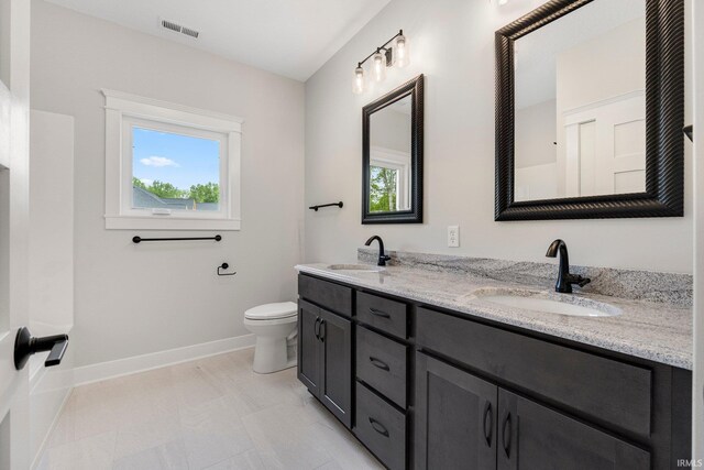 13335 Passerine Blvd, Fort Wayne, IN 46845 - full bathroom featuring double vanity, toilet, and baseboards