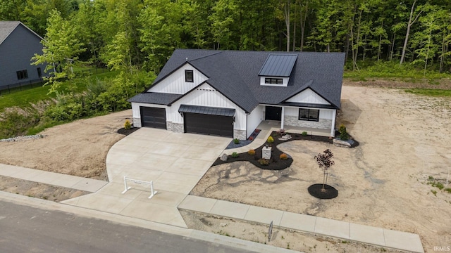 13335 Passerine Blvd, Fort Wayne, IN 46845 - modern farmhouse with stone siding, board and batten siding, concrete driveway, a garage, and a shingled roof