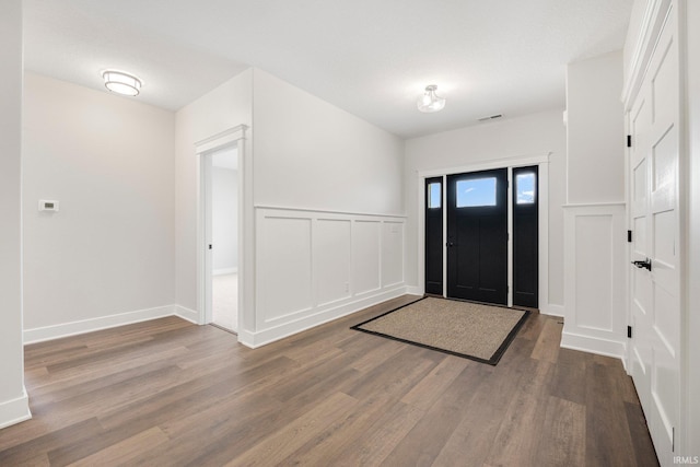 13335 Passerine Blvd, Fort Wayne, IN 46845 - entryway featuring wood finished floors, a decorative wall, and wainscoting