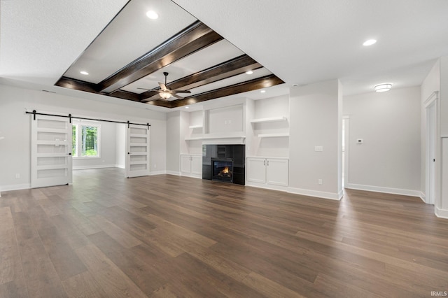 13335 Passerine Blvd, Fort Wayne, IN 46845 - unfurnished living room featuring a barn door, ceiling fan, baseboards, dark wood finished floors, and beam ceiling