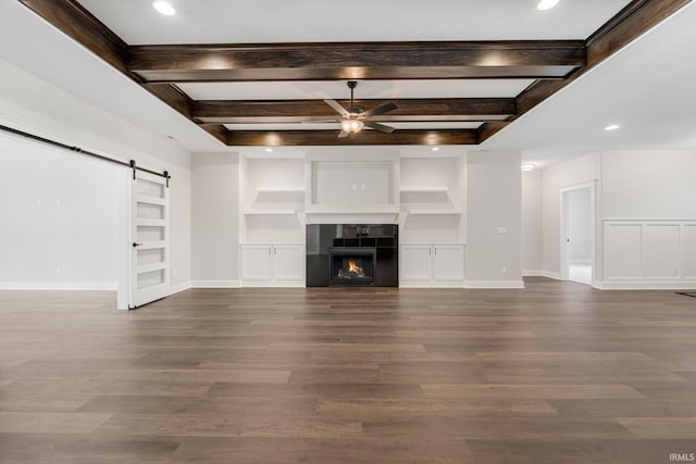 13335 Passerine Blvd, Fort Wayne, IN 46845 - unfurnished living room with ceiling fan, a barn door, built in shelves, beam ceiling, and dark wood-style flooring