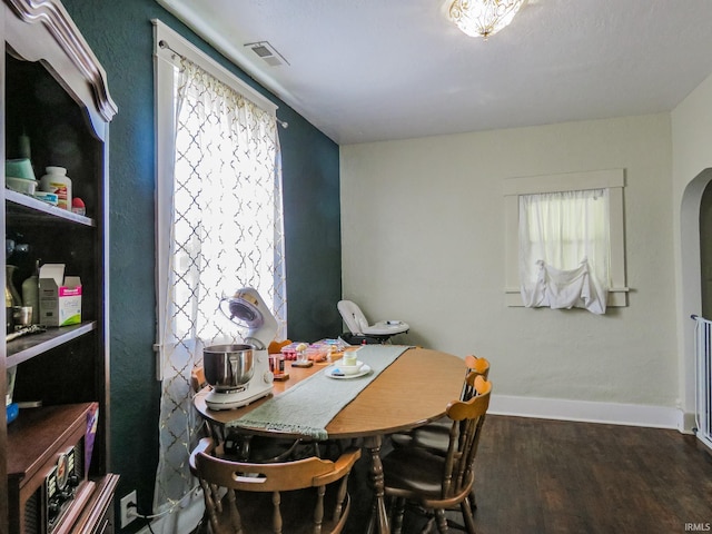 302 E Main St, Swayzee, IN 46986 - dining area with wood finished floors, arched walkways, and baseboards
