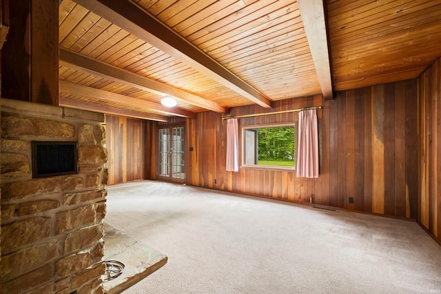 4837 Covered Bridge Rd, Nashville, IN 47448 - unfurnished living room with carpet, wooden walls, wood ceiling with exposed beams, and a stone fireplace