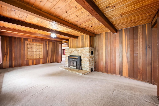 4837 Covered Bridge Rd, Nashville, IN 47448 - unfurnished living room featuring wooden walls, wood ceiling with exposed beams, carpet flooring, and a stone fireplace